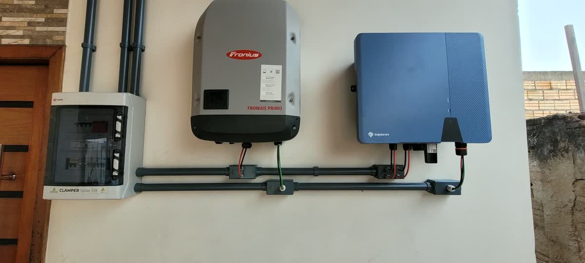 Inversores Fronius Primo e Solplanet dividindo a mesma parede, com string box Clamper